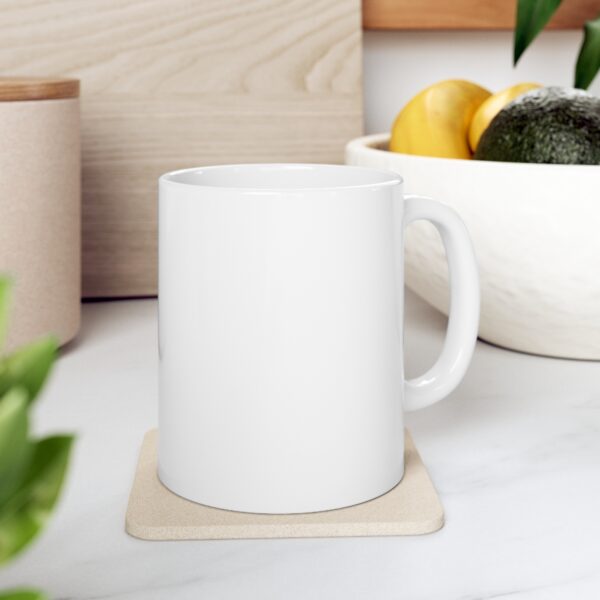 A mug on a coaster in a kitchen.