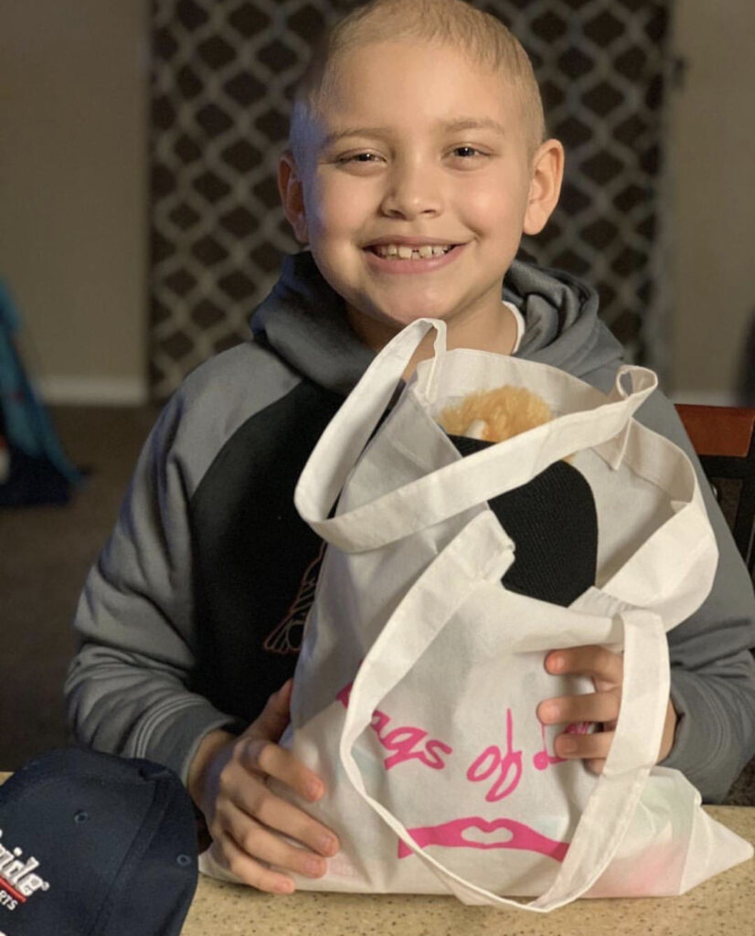 Cancer patient smiling with care package.