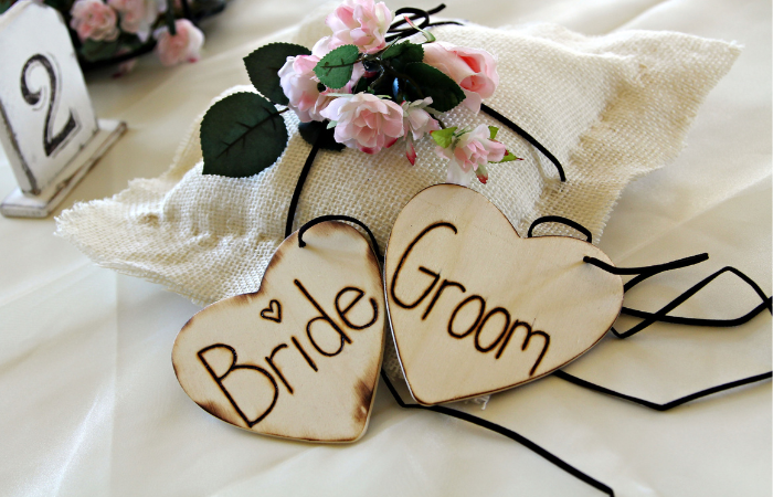 Wooden sign with 'bride and groom.'